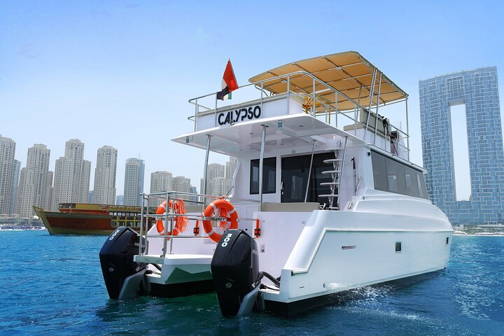 Set sail on a luxurious yacht cruising through Dubai's iconic skyline indulging in a buffet of international dishes and soft drinks while soaking in the stunning views of landmark destinations.